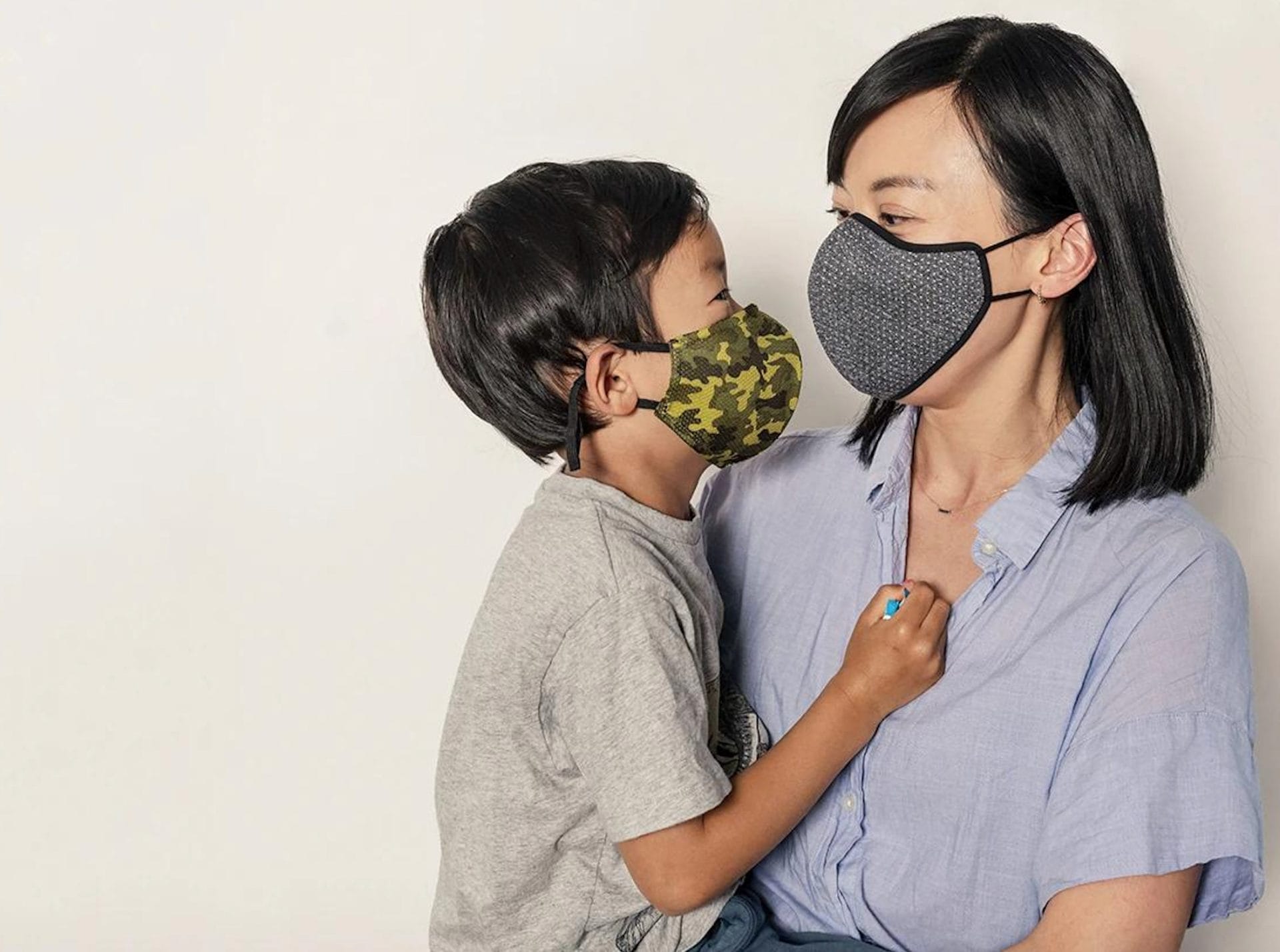 Woman and child wearing Happy Masks